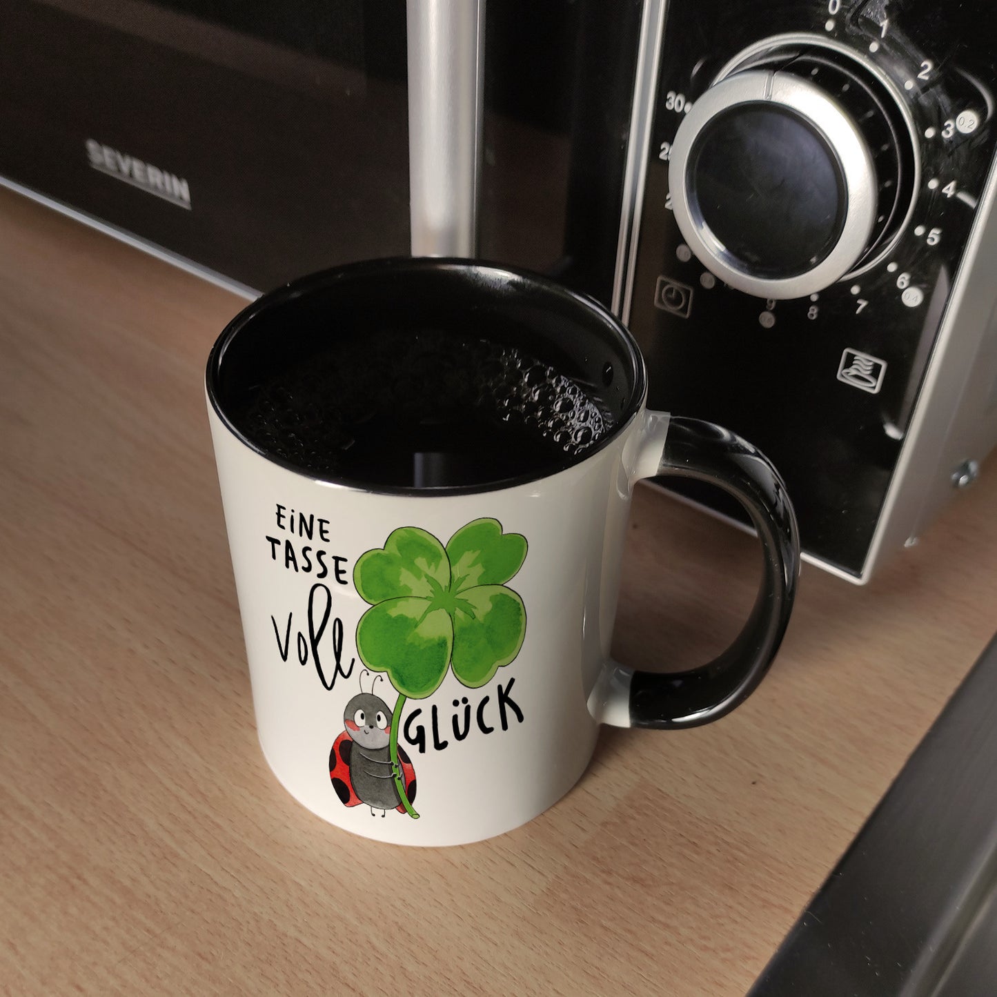 Marienkäfer Kaffeebecher in schwarz mit Spruch Eine Tasse voll Glück