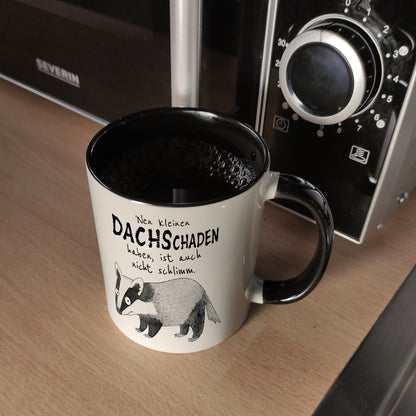 Dachs Kaffeebecher in schwarz mit Spruch Kleiner Dachschaden nicht schlimm