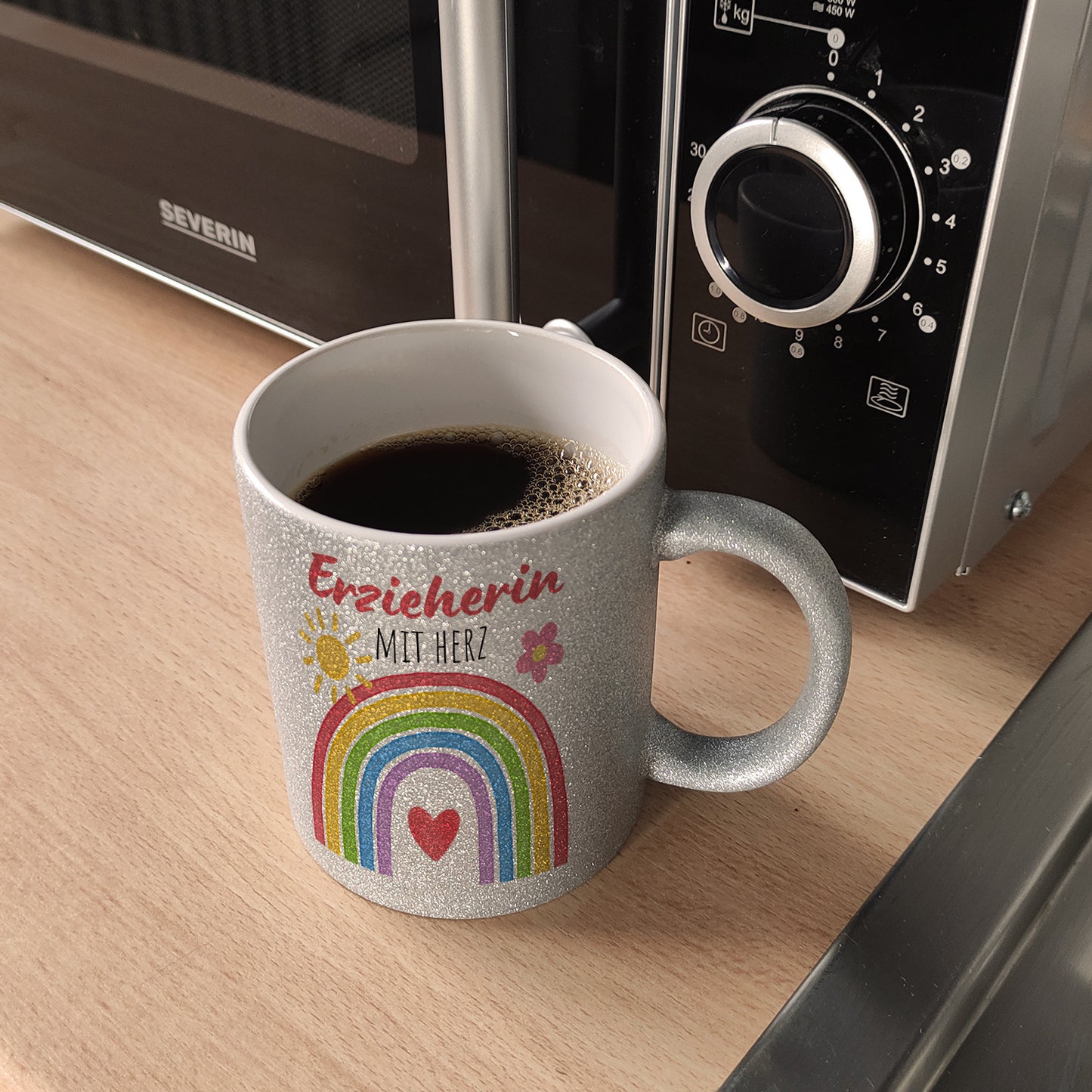 Regenbogen Glitzer-Kaffeebecher mit Spruch Erzieherin mit Herz