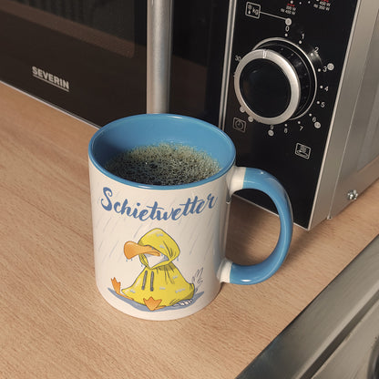 Möwe Kaffeebecher in hellblau mit Spruch Schietwetter