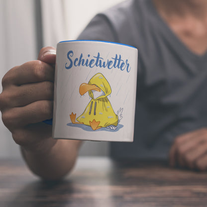 Möwe Kaffeebecher in hellblau mit Spruch Schietwetter