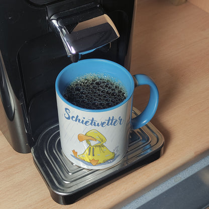 Möwe Kaffeebecher in hellblau mit Spruch Schietwetter